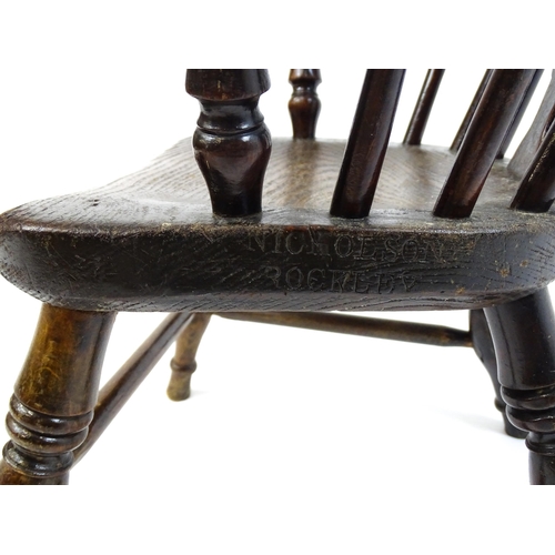 1475 - A 19thC child's yew wood Windsor chair by George Nicholson of Rockley, the chair having a pierced ba... 