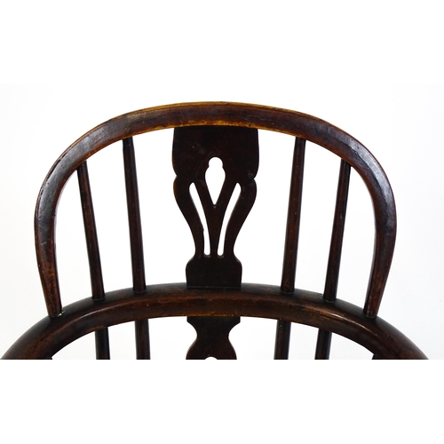 1475 - A 19thC child's yew wood Windsor chair by George Nicholson of Rockley, the chair having a pierced ba... 