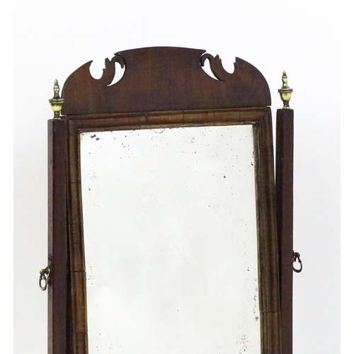 1477 - A 19thC walnut toilet mirror with a moulded frame, tapering uprights surmounted by brass finials and... 