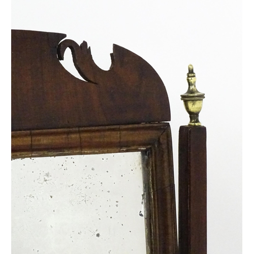 1477 - A 19thC walnut toilet mirror with a moulded frame, tapering uprights surmounted by brass finials and... 