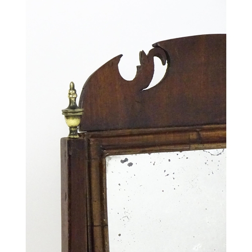 1477 - A 19thC walnut toilet mirror with a moulded frame, tapering uprights surmounted by brass finials and... 