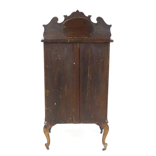 1483 - An Edwardian mahogany display cabinet with a mirrored upstand above a single glazed door with pierce... 