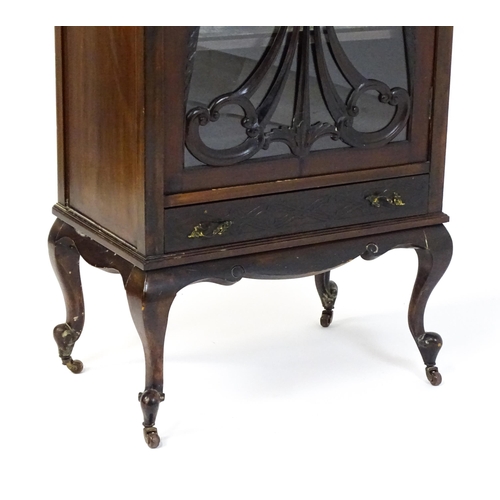 1483 - An Edwardian mahogany display cabinet with a mirrored upstand above a single glazed door with pierce... 