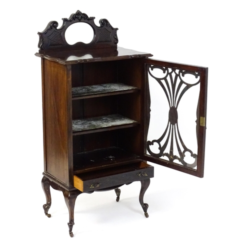 1483 - An Edwardian mahogany display cabinet with a mirrored upstand above a single glazed door with pierce... 