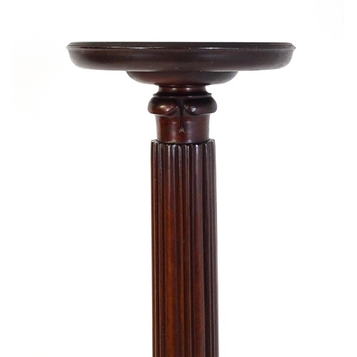 1485 - An early 20thC mahogany torchiere with a dished top above a turned reeded column with carved floral ... 