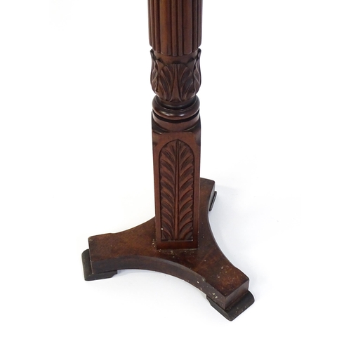 1485 - An early 20thC mahogany torchiere with a dished top above a turned reeded column with carved floral ... 