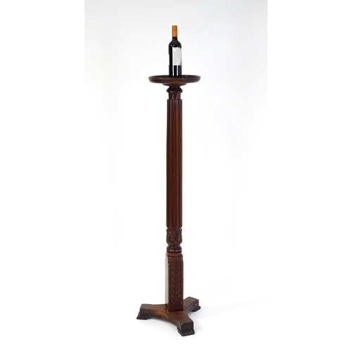 1485 - An early 20thC mahogany torchiere with a dished top above a turned reeded column with carved floral ... 