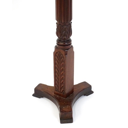 1485 - An early 20thC mahogany torchiere with a dished top above a turned reeded column with carved floral ... 