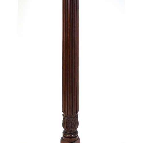 1485 - An early 20thC mahogany torchiere with a dished top above a turned reeded column with carved floral ... 