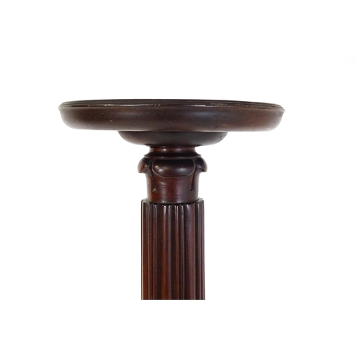 1485 - An early 20thC mahogany torchiere with a dished top above a turned reeded column with carved floral ... 