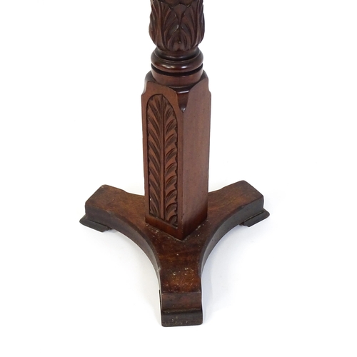 1485 - An early 20thC mahogany torchiere with a dished top above a turned reeded column with carved floral ... 