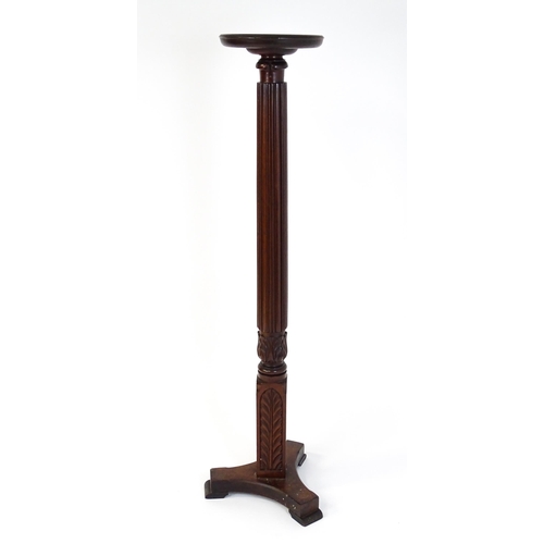 1485 - An early 20thC mahogany torchiere with a dished top above a turned reeded column with carved floral ... 