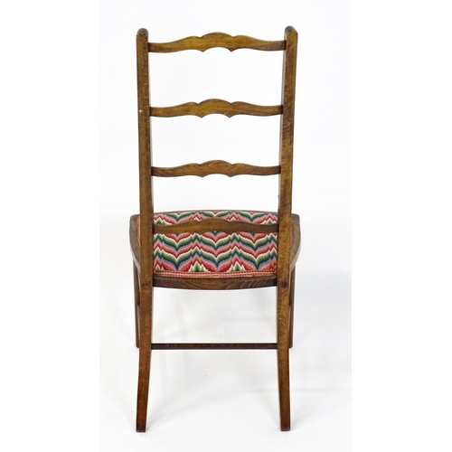 1489 - An early / mid 20thC side chair with a ladderback above an upholstered seat and raised on turned tap... 