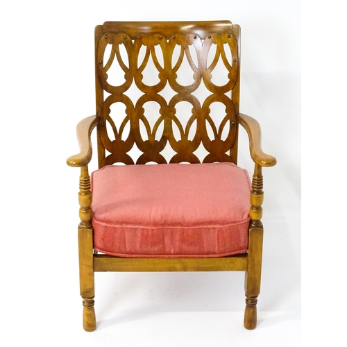 1490 - A mid 20thC elbow chair by Birchcraft of High Wycombe, the back rest having repeating pierced decora... 