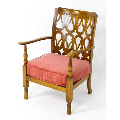 1490 - A mid 20thC elbow chair by Birchcraft of High Wycombe, the back rest having repeating pierced decora... 