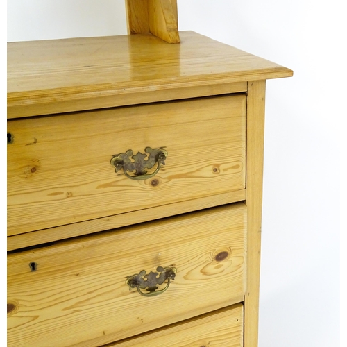 1493 - An early 20thC pine dressing table decorated with pierced heart shaped motifs, having a bevelled mir... 