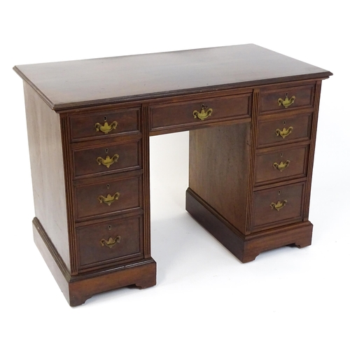 1437 - An Edwardian 'James Shoolbred & Co' walnut double pedestal desk with a single central drawer flanked... 