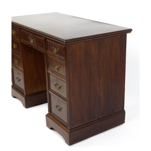 1437 - An Edwardian 'James Shoolbred & Co' walnut double pedestal desk with a single central drawer flanked... 