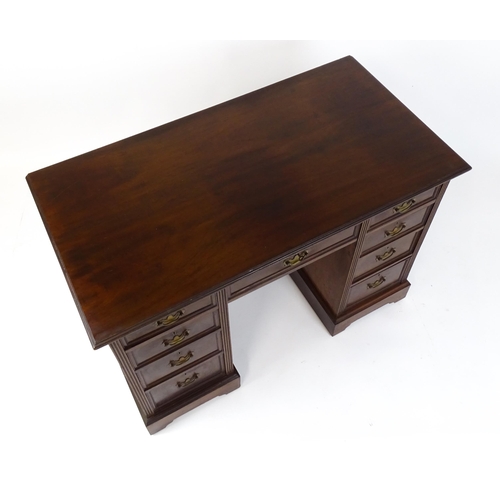 1437 - An Edwardian 'James Shoolbred & Co' walnut double pedestal desk with a single central drawer flanked... 