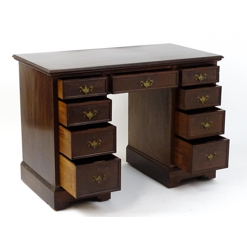 1437 - An Edwardian 'James Shoolbred & Co' walnut double pedestal desk with a single central drawer flanked... 