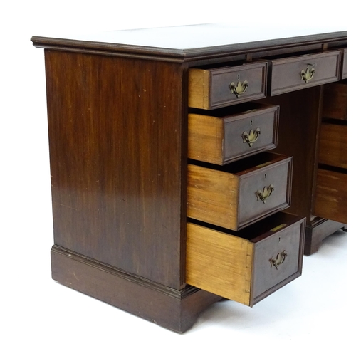 1437 - An Edwardian 'James Shoolbred & Co' walnut double pedestal desk with a single central drawer flanked... 