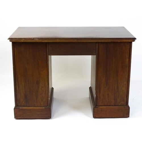 1437 - An Edwardian 'James Shoolbred & Co' walnut double pedestal desk with a single central drawer flanked... 