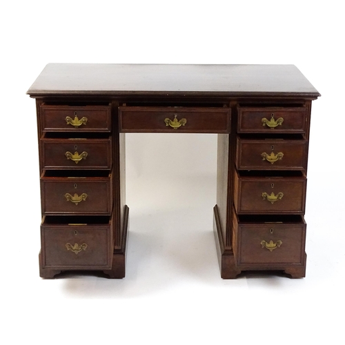 1437 - An Edwardian 'James Shoolbred & Co' walnut double pedestal desk with a single central drawer flanked... 