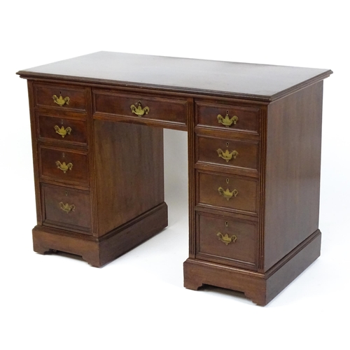 1437 - An Edwardian 'James Shoolbred & Co' walnut double pedestal desk with a single central drawer flanked... 