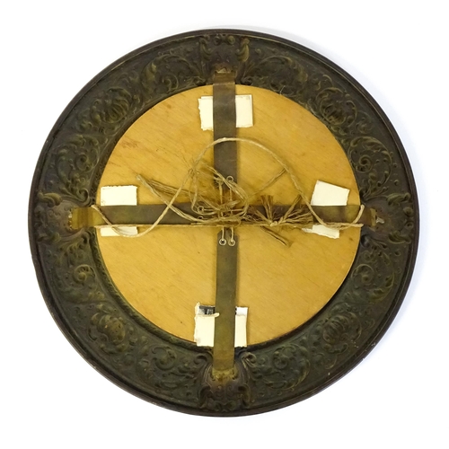 1482 - An early 20thC circular mirror with a brass embossed frame. 24