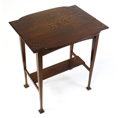 1436 - An Arts & Crafts table with a floral marquetry inlaid top and set with heart motifs to the corners, ... 