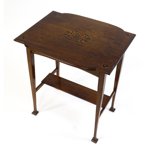 1436 - An Arts & Crafts table with a floral marquetry inlaid top and set with heart motifs to the corners, ... 