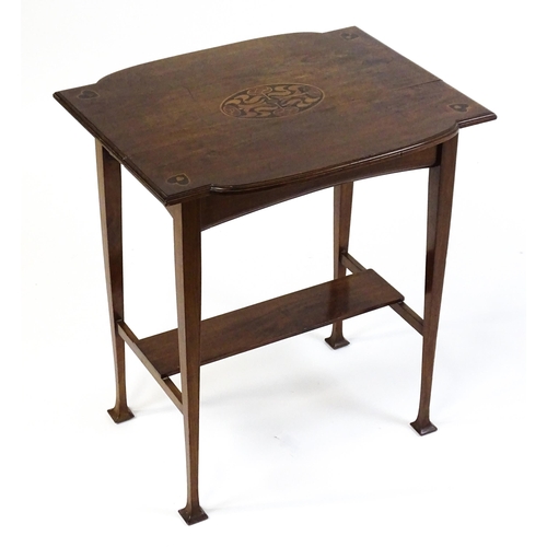 1436 - An Arts & Crafts table with a floral marquetry inlaid top and set with heart motifs to the corners, ... 