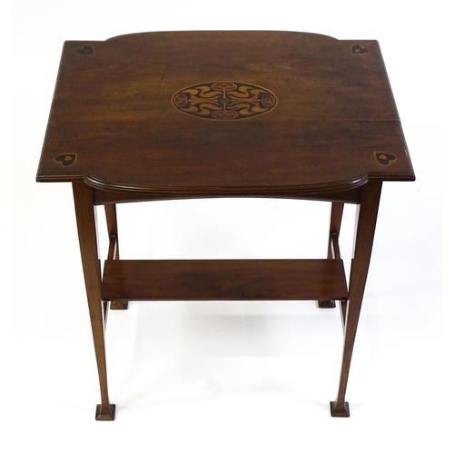 1436 - An Arts & Crafts table with a floral marquetry inlaid top and set with heart motifs to the corners, ... 