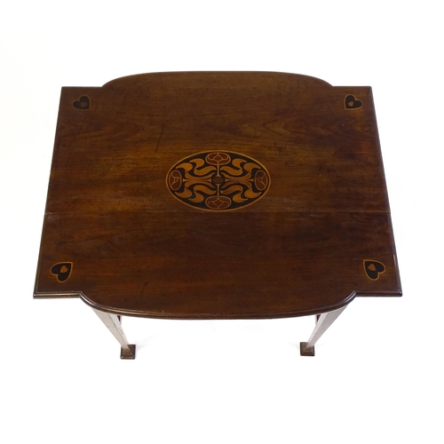 1436 - An Arts & Crafts table with a floral marquetry inlaid top and set with heart motifs to the corners, ... 