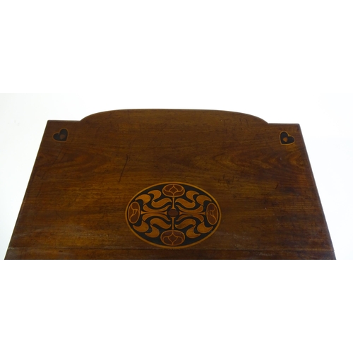 1436 - An Arts & Crafts table with a floral marquetry inlaid top and set with heart motifs to the corners, ... 