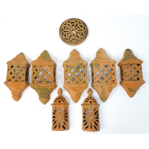 1306 - Assorted terracotta items comprising five Mediterranean-style garden wall light covers, together wit... 