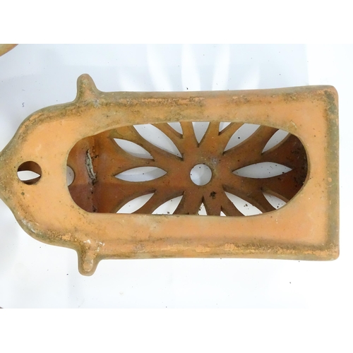 1306 - Assorted terracotta items comprising five Mediterranean-style garden wall light covers, together wit... 