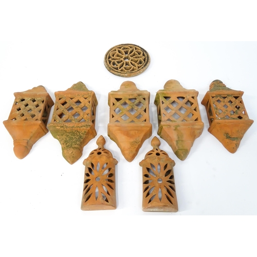 1306 - Assorted terracotta items comprising five Mediterranean-style garden wall light covers, together wit... 