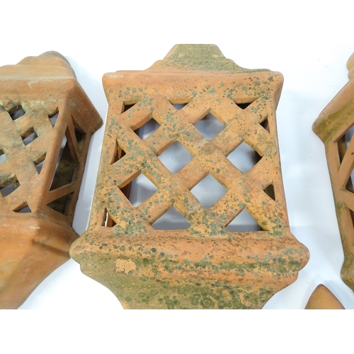 1306 - Assorted terracotta items comprising five Mediterranean-style garden wall light covers, together wit... 