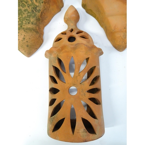 1306 - Assorted terracotta items comprising five Mediterranean-style garden wall light covers, together wit... 