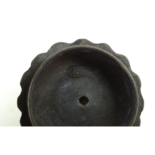 10 - A small Chinese Yixing teapot of lobed form, the lid with bird head finial. Character marks under li... 