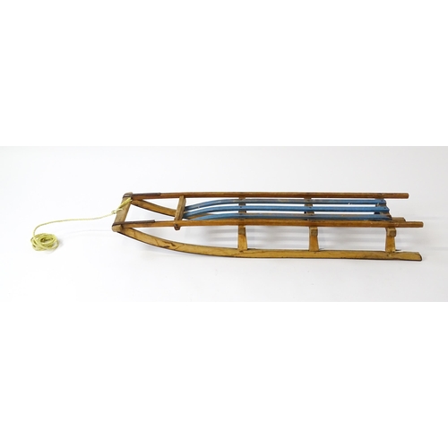 1235 - An early 20thC wooden sledge / toboggan. Approx. 45