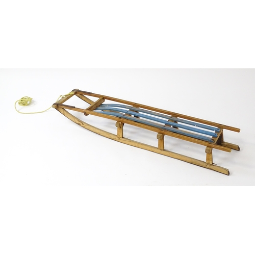 1235 - An early 20thC wooden sledge / toboggan. Approx. 45