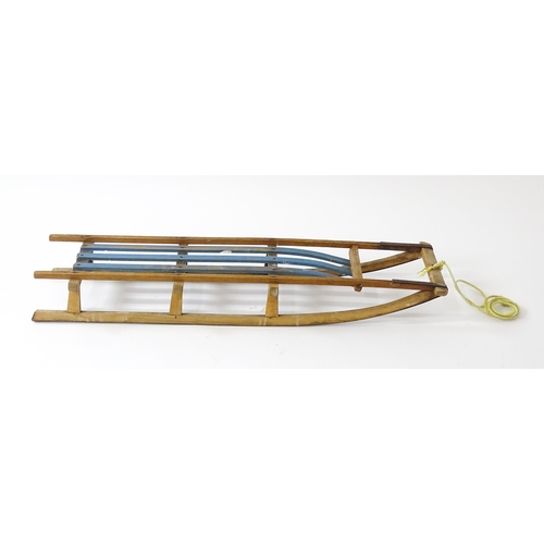 1235 - An early 20thC wooden sledge / toboggan. Approx. 45