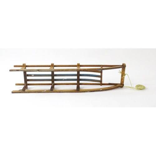 1235 - An early 20thC wooden sledge / toboggan. Approx. 45