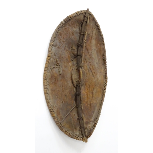 1238 - Ethnographic / Native / Tribal : An African Maasai Kenya hide shield of lozenge form, with traces of... 