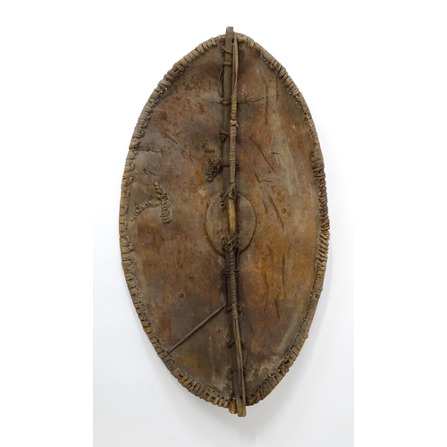 1238 - Ethnographic / Native / Tribal : An African Maasai Kenya hide shield of lozenge form, with traces of... 