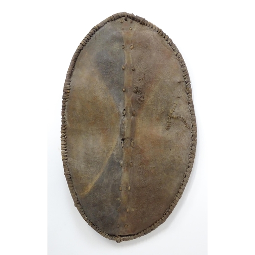 1238 - Ethnographic / Native / Tribal : An African Maasai Kenya hide shield of lozenge form, with traces of... 