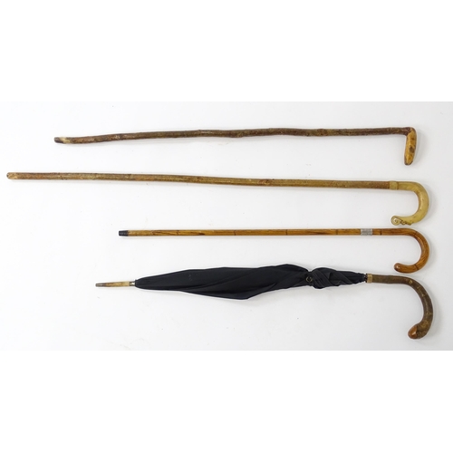 1244 - Three assorted 20thC walking sticks, to include a Scottish example with a horn handle having carved ... 