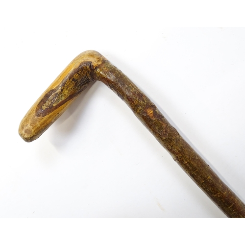 1244 - Three assorted 20thC walking sticks, to include a Scottish example with a horn handle having carved ... 